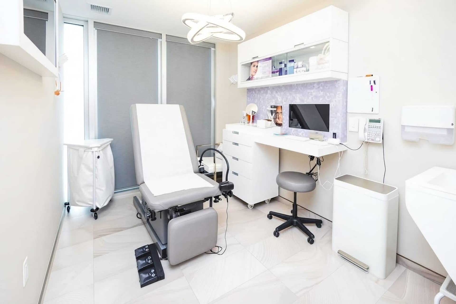 An exam room with a treatment table and workstation